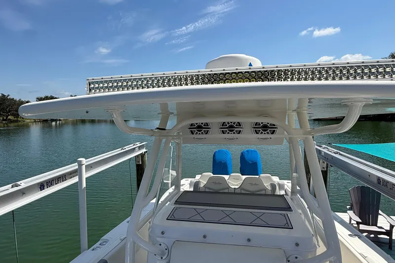  Yacht Photos Pics 2005 Marlago 35 boat docked on a serene lake under a clear blue sky.