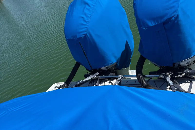  Yacht Photos Pics Covered engines on a 2005 Marlago 35 boat, docked on calm water.