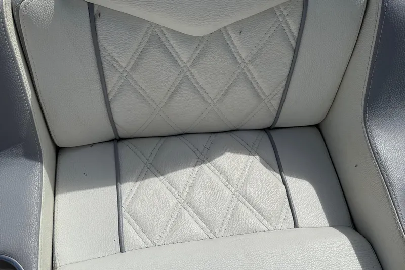  Yacht Photos Pics Quilted white leather seat of 2005 Marlago 35 boat, showcasing elegant design.
