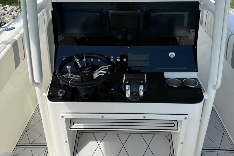  Yacht Photos Pics Helm of 2005 Marlago 35 boat with steering wheel and control panel.