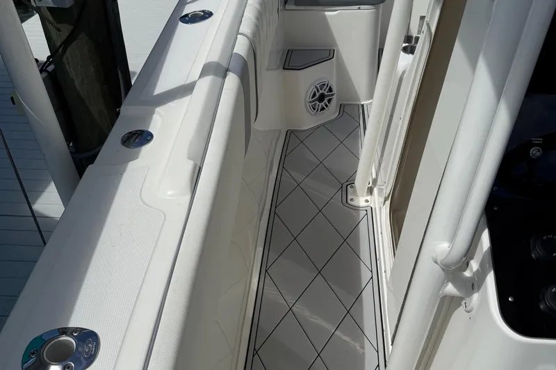  Yacht Photos Pics Interior view of a 2005 Marlago 35 boat, featuring sleek white design and diamond-patterned flooring.
