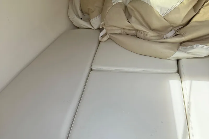  Yacht Photos Pics Interior seating of a 2005 Marlago 35 boat with beige cushions.