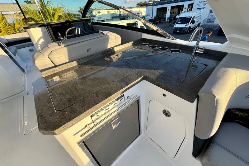  Yacht Photos Pics Luxury outdoor kitchen on 2026 Four Winns H33 OB boat with sleek countertop and sink.