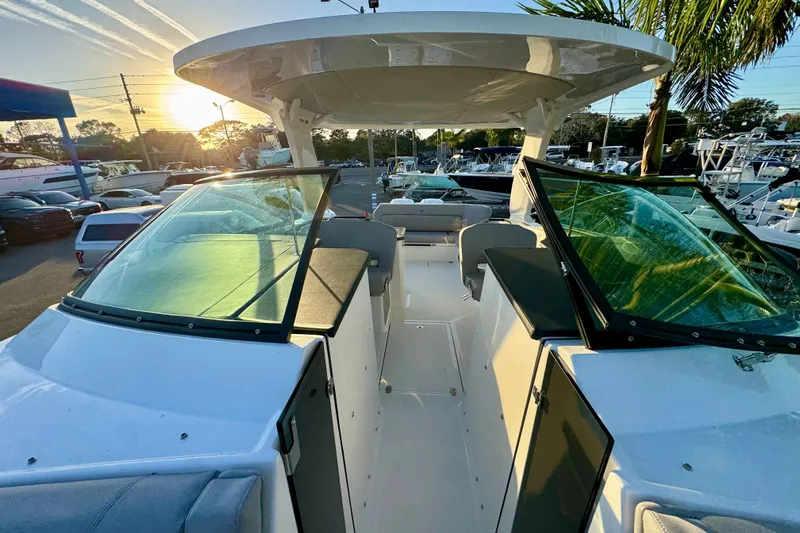 Yacht Photos Pics 2026 Four Winns H33 OB boat interior with sunset view, showcasing sleek design and spacious seating.