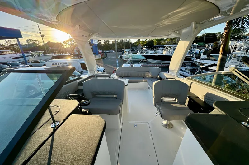  Yacht Photos Pics 2026 Four Winns H33 OB boat interior with seating, helm, and sunset view.