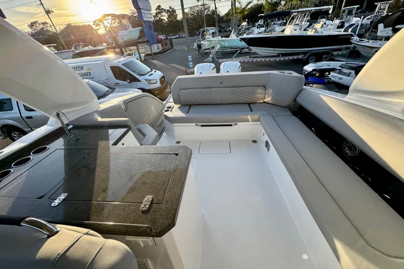  Yacht Photos Pics 2026 Four Winns H33 OB boat interior with seating and countertop at sunset.