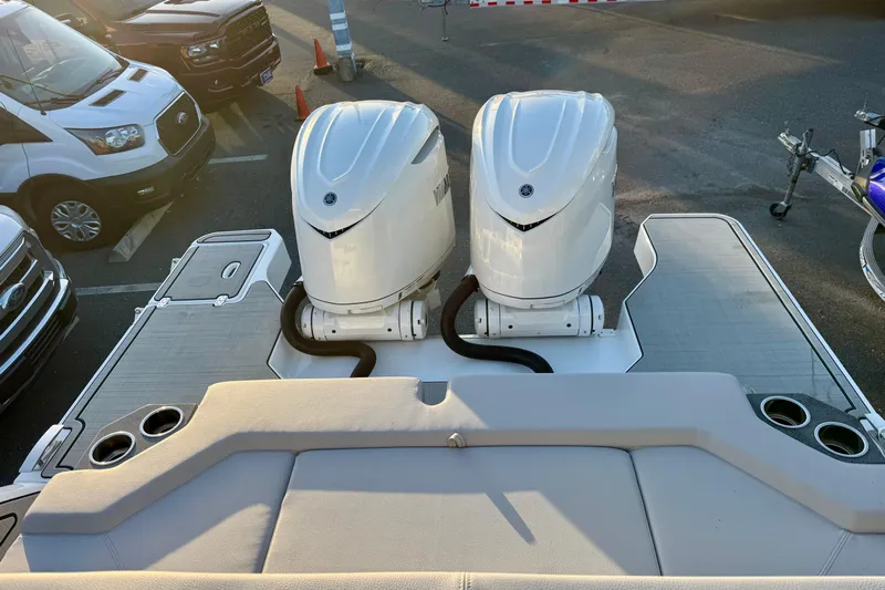  Yacht Photos Pics 2026 Four Winns H33 OB boat with dual outboard engines in a parking lot.