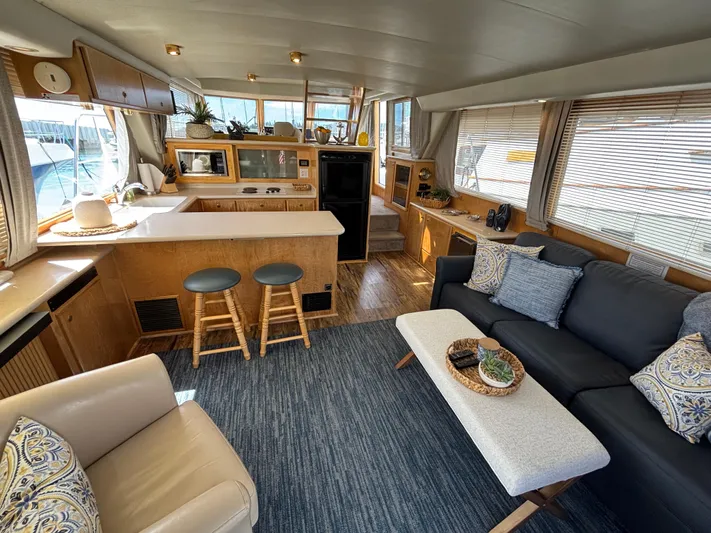 Orca Belle Yacht Photos Pics Luxurious interior of a 2000 Navigator 5300 yacht with modern furnishings and kitchen area.