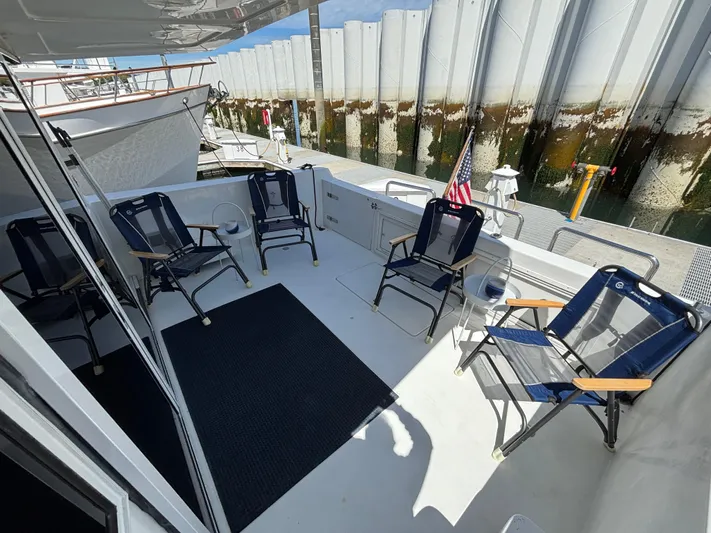 Orca Belle Yacht Photos Pics Deck of 2000 Navigator 5300 yacht with chairs and American flag.