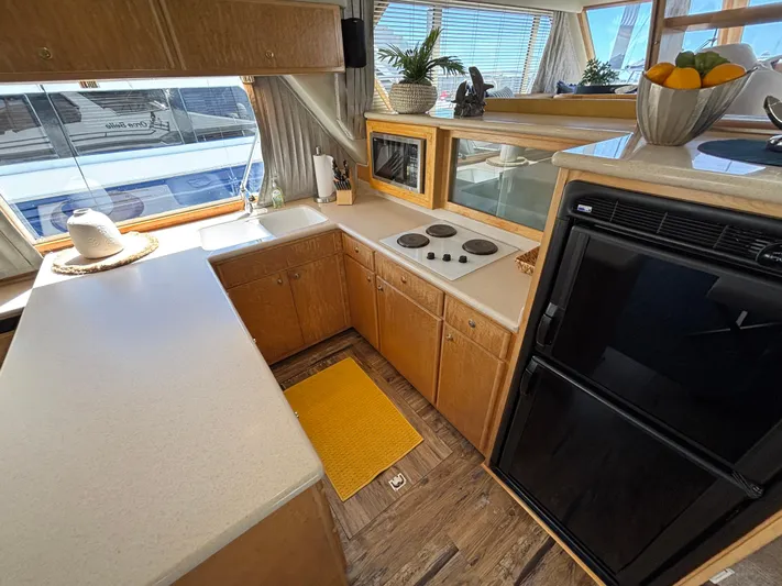Orca Belle Yacht Photos Pics Navigator 5300 yacht kitchen, 2000 model, featuring modern appliances and wooden cabinetry.