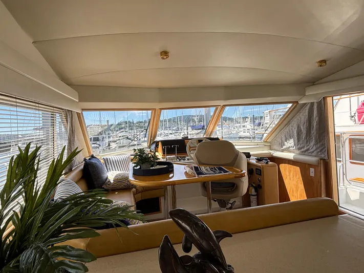 Orca Belle Yacht Photos Pics Interior of 2000 Navigator 5300 yacht with marina view through large windows.