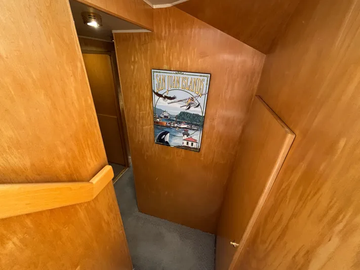 Orca Belle Yacht Photos Pics Interior hallway of 2000 Navigator 5300 yacht with wooden paneling and wall art.