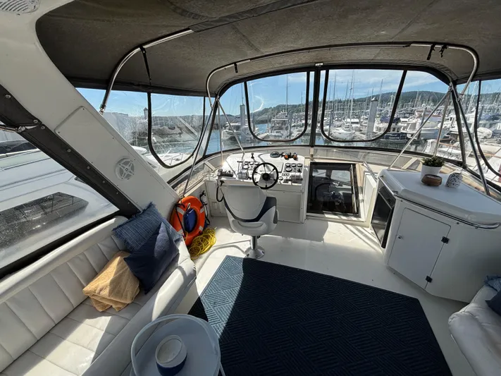 Orca Belle Yacht Photos Pics Interior of 2000 Navigator 5300 yacht with helm, seating, and marina view.