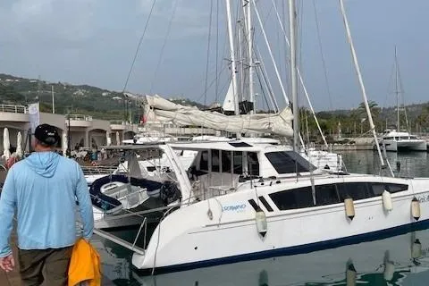 Seis Al Mar Yacht Photos Pics 2018 Seawind 1260 catamaran docked at marina with person walking nearby.