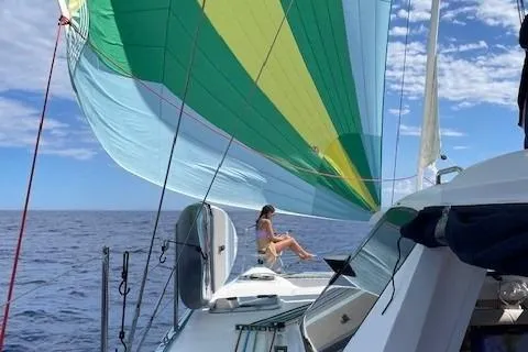 Seis Al Mar Yacht Photos Pics 2018 Seawind 1260 sailing with colorful spinnaker on open ocean.