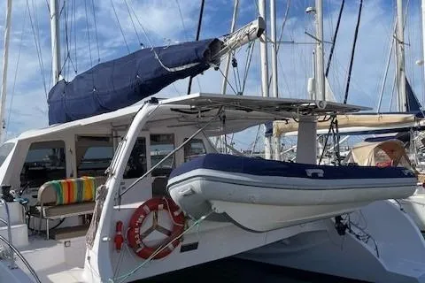 Seis Al Mar Yacht Photos Pics 2018 Seawind 1260 catamaran docked with dinghy and colorful seating.