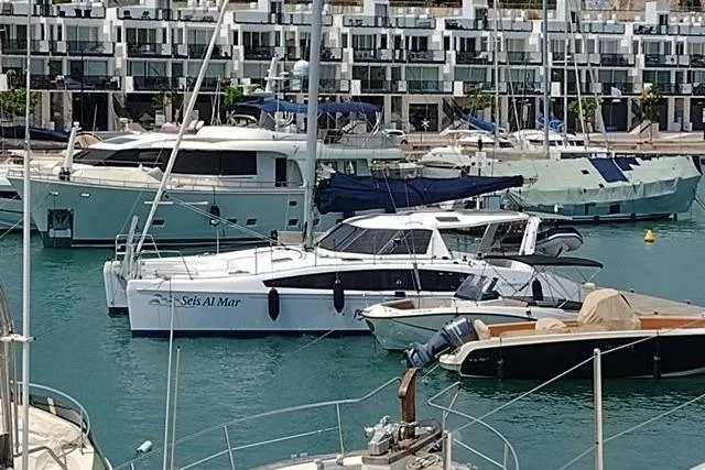 Seis Al Mar Yacht Photos Pics 2018 Seawind 1260 catamaran docked in a marina with other boats.
