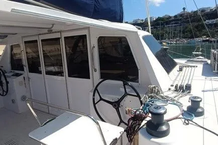 Seis Al Mar Yacht Photos Pics 2018 Seawind 1260 catamaran with dual steering wheels, docked in a sunny marina.