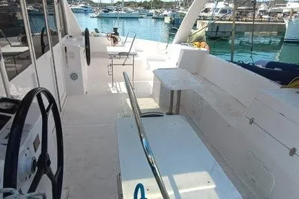 Seis Al Mar Yacht Photos Pics 2018 Seawind 1260 catamaran cockpit with seating, steering wheel, and marina view.