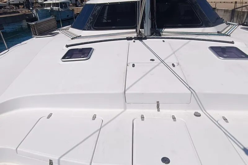 Seis Al Mar Yacht Photos Pics 2018 Seawind 1260 catamaran deck with hatches and rigging in a marina setting.