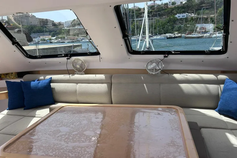 Seis Al Mar Yacht Photos Pics Interior of 2018 Seawind 1260 catamaran with comfortable seating and scenic marina view.