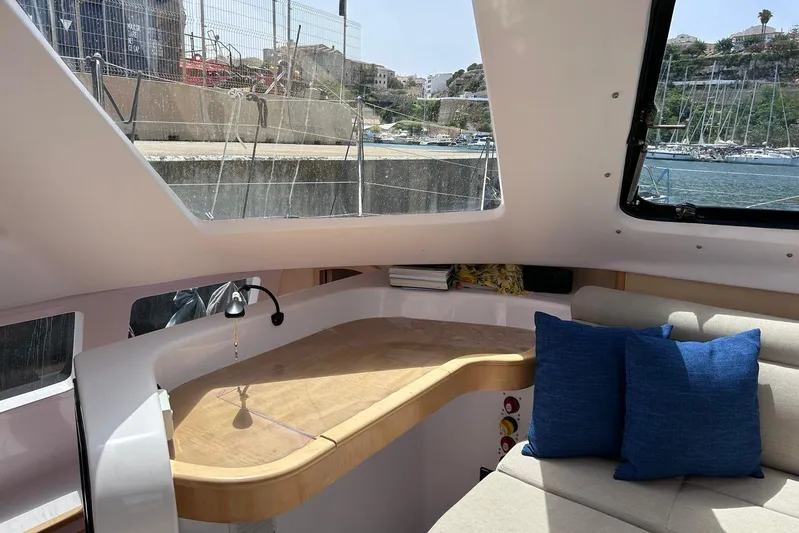 Seis Al Mar Yacht Photos Pics Interior of 2018 Seawind 1260 catamaran with cozy seating and large windows.