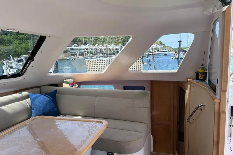 Seis Al Mar Yacht Photos Pics Interior of 2018 Seawind 1260 catamaran with cozy seating and marina view.