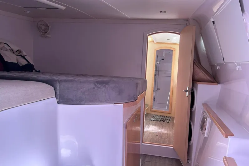 Seis Al Mar Yacht Photos Pics Interior of 2018 Seawind 1260 catamaran, featuring a cozy cabin and bathroom.