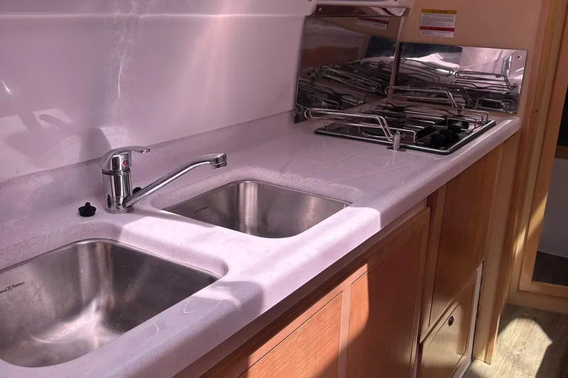 Seis Al Mar Yacht Photos Pics Modern kitchen in 2018 Seawind 1260 yacht with dual sinks and stove.