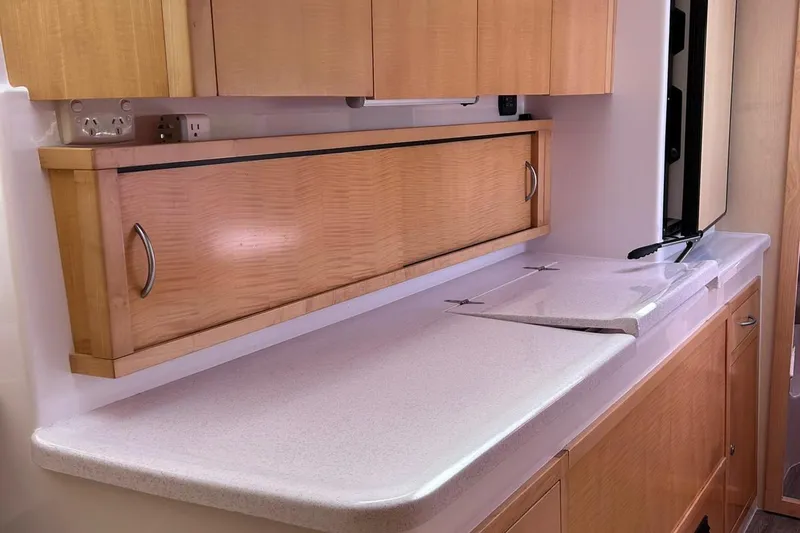 Seis Al Mar Yacht Photos Pics Interior of 2018 Seawind 1260 yacht with sleek wooden cabinetry and countertop.