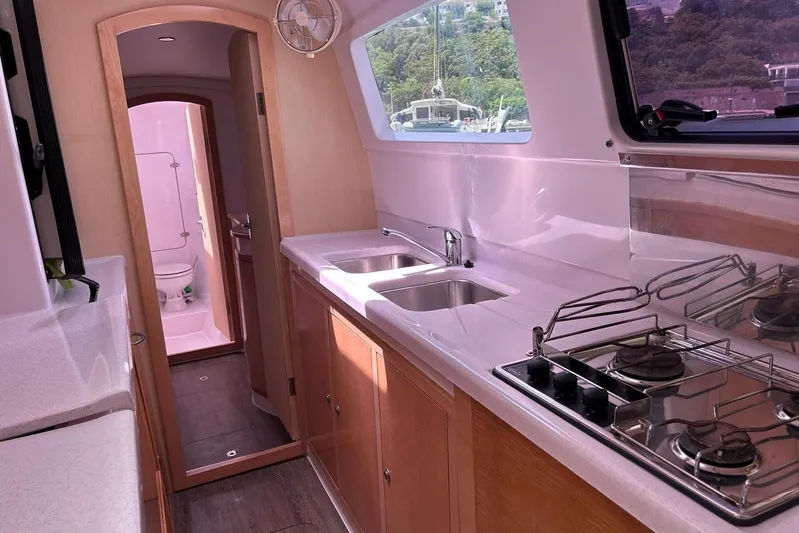 Seis Al Mar Yacht Photos Pics Interior of 2018 Seawind 1260 catamaran featuring modern kitchen and bathroom.
