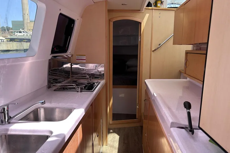 Seis Al Mar Yacht Photos Pics Interior of 2018 Seawind 1260 catamaran, featuring modern kitchen with dual sinks and stove.