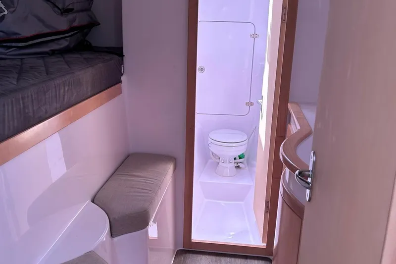 Seis Al Mar Yacht Photos Pics Interior of 2018 Seawind 1260 catamaran featuring a compact bathroom and cozy sleeping area.