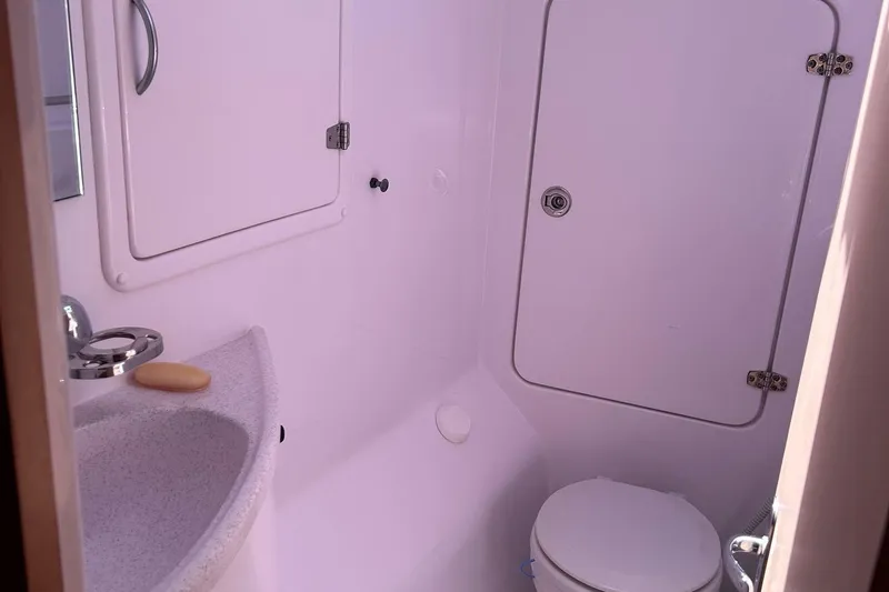 Seis Al Mar Yacht Photos Pics Bathroom interior of 2018 Seawind 1260 yacht, featuring sink and toilet.