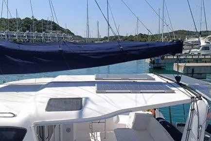 Seis Al Mar Yacht Photos Pics 2018 Seawind 1260 catamaran with solar panel, docked in a marina.