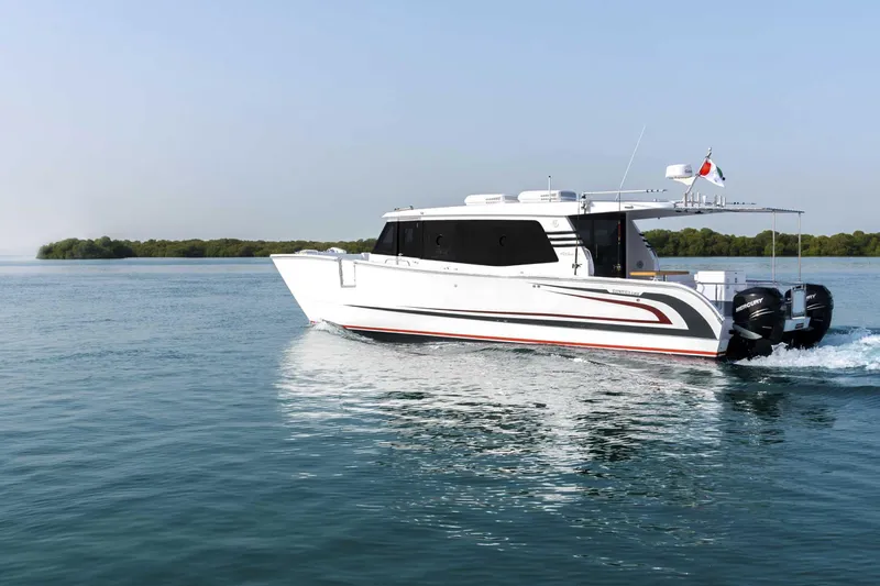  Yacht Photos Pics 2026 SilverCAT 40LUX boat cruising on calm water with lush greenery in the background.