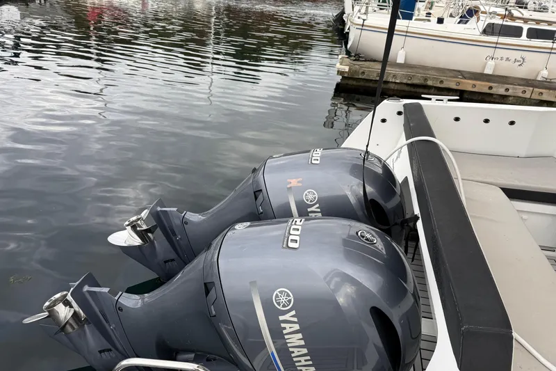  Yacht Photos Pics Twin Yamaha 200 outboard engines on a 2019 Jeanneau NC 895 boat at a marina.