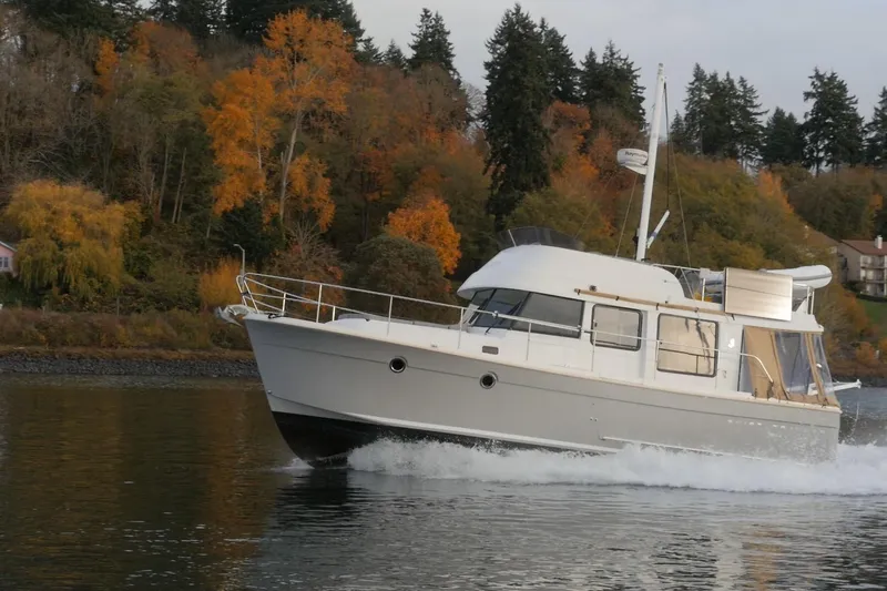 Sante Yacht Photos Pics 2013 Beneteau Swift Trawler 34 Fly cruising on a scenic autumn lake.