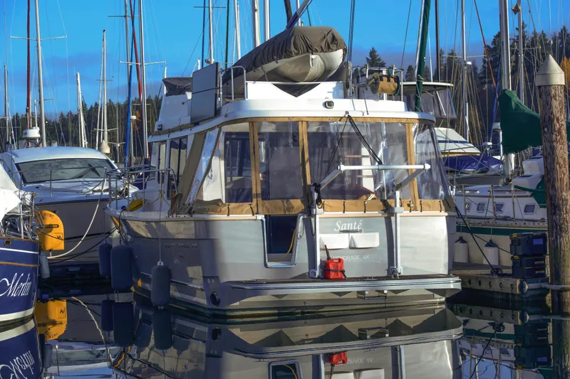 Sante Yacht Photos Pics 2013 Beneteau Swift Trawler 34 Fly moored in a marina, surrounded by other boats.