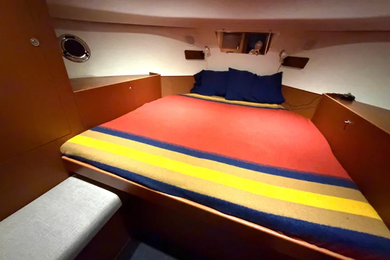 Sante Yacht Photos Pics Cozy cabin interior of 2013 Beneteau Swift Trawler 34 Fly with colorful bedding.