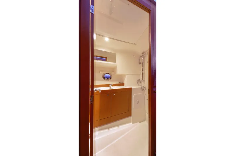 Sante Yacht Photos Pics Bathroom interior of 2013 Beneteau Swift Trawler 34 Fly yacht, featuring wooden cabinetry.
