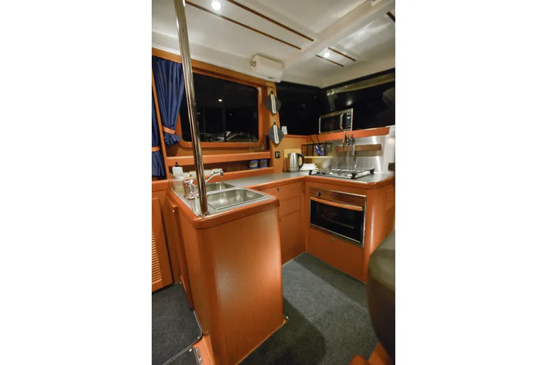 Sante Yacht Photos Pics Interior of 2013 Beneteau Swift Trawler 34 Fly, featuring a compact kitchen area.