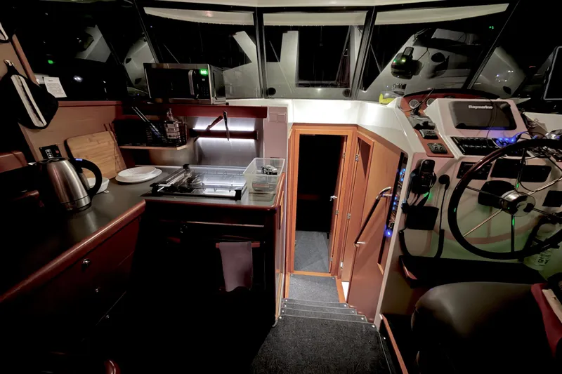 Sante Yacht Photos Pics Interior of 2013 Beneteau Swift Trawler 34 Fly, featuring helm and galley area.