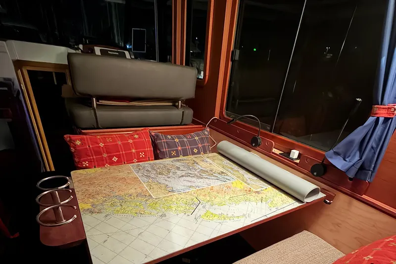 Sante Yacht Photos Pics Interior of 2013 Beneteau Swift Trawler 34 Fly with nautical chart on table.