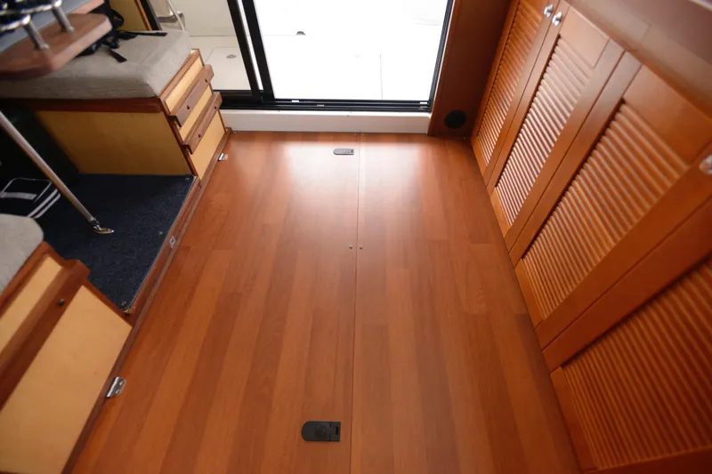 Sante Yacht Photos Pics Interior of 2013 Beneteau Swift Trawler 34 Fly, featuring wooden flooring and cabinetry.