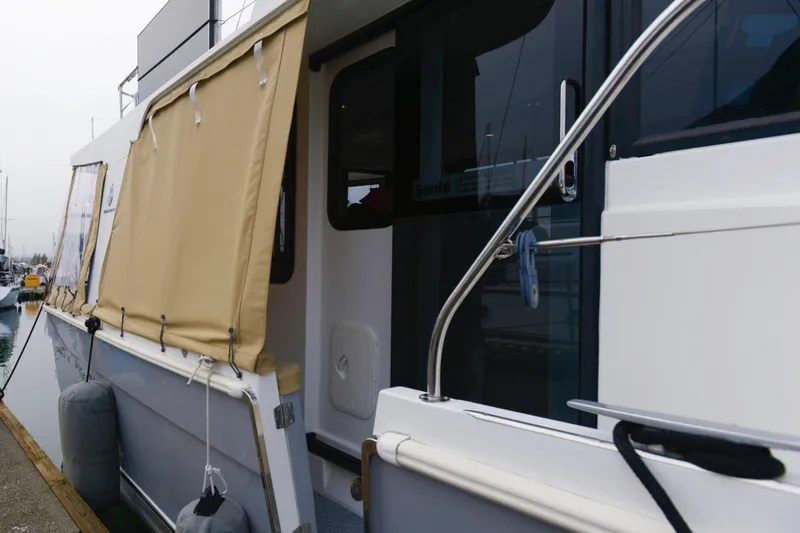 Sante Yacht Photos Pics 2013 Beneteau Swift Trawler 34 Fly docked, featuring beige canvas covers and stainless steel railings.