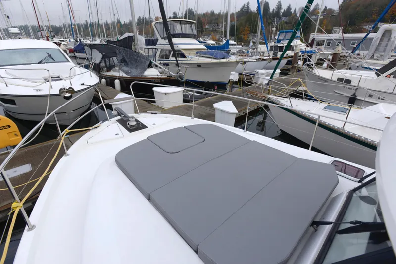 Sante Yacht Photos Pics 2013 Beneteau Swift Trawler 34 Fly docked among other boats in a marina.