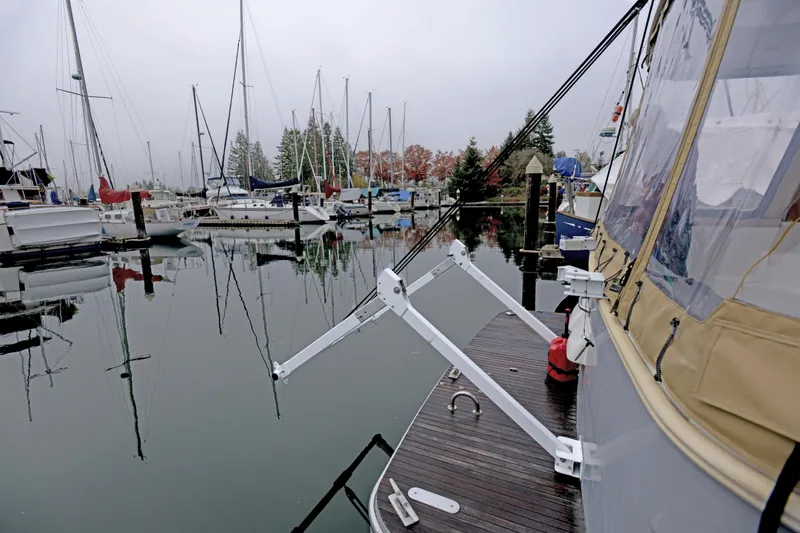 Sante Yacht Photos Pics 2013 Beneteau Swift Trawler 34 Fly docked in a marina with sailboats.