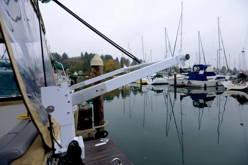 Sante Yacht Photos Pics 2013 Beneteau Swift Trawler 34 Fly at marina, surrounded by sailboats and calm water.