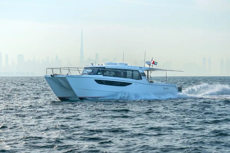  Yacht Photos Pics Luxury SilverCAT 46LUX yacht cruising on open sea, city skyline in background, 2026 model.